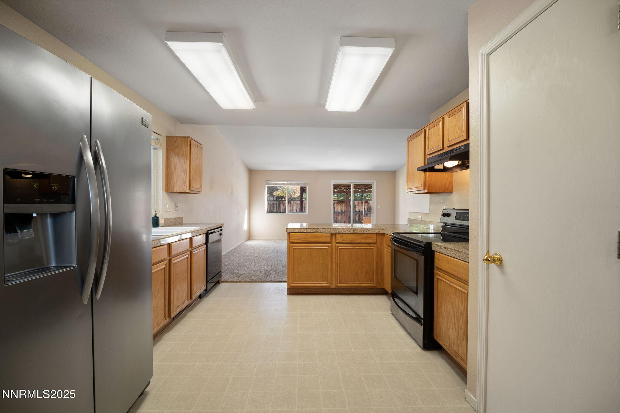 9770 Brightridge Drive Reno, NV 89506 - Photo 6 of 43 a large kitchen with a refrigerator a sink dishwasher stove and oven