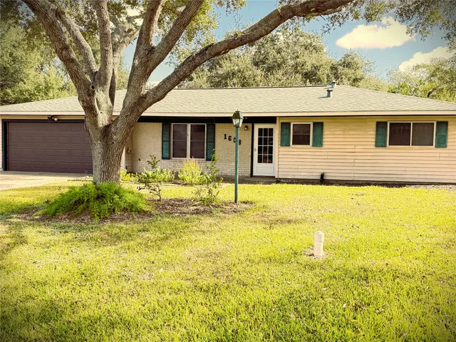 a front view of a house with yard and garage