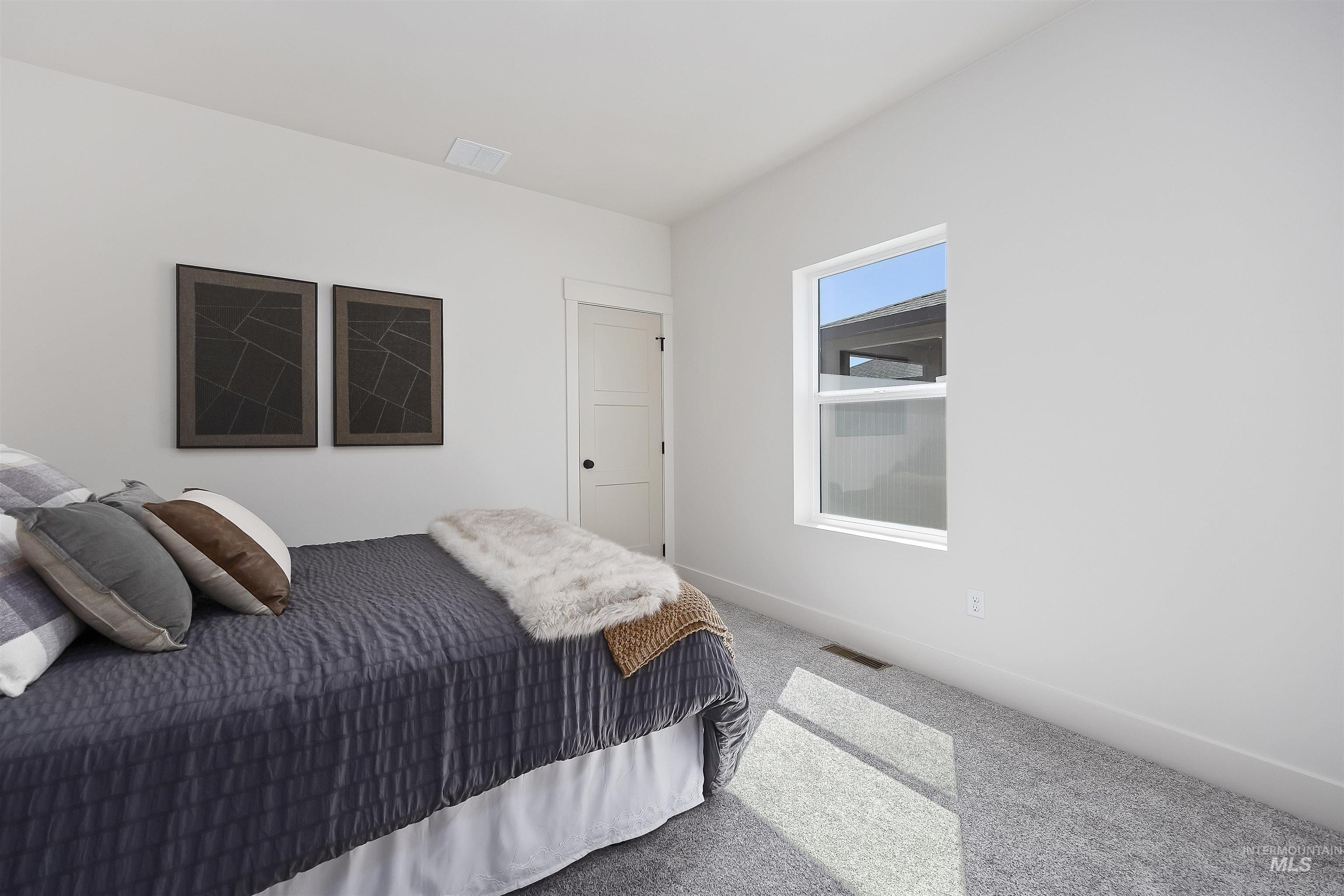 2017 Sparrow Street Rupert, ID 83350 - Photo 23 of 26 Carpeted room with white walls, a single window, and a three-panel interior door