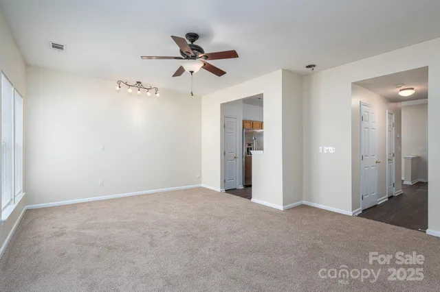 a view of a big room with closet and windows