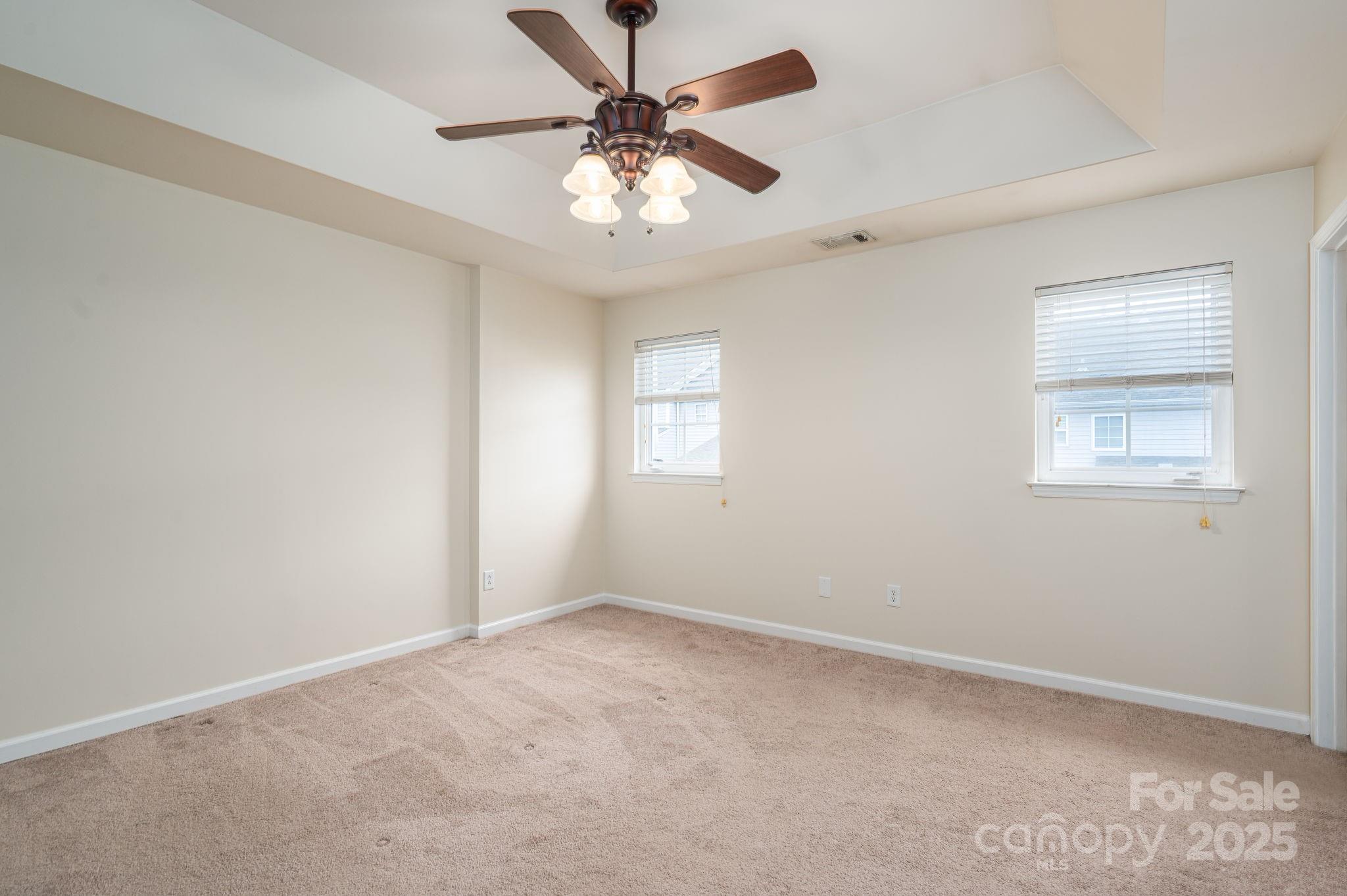 7937 Mariners Pointe Circle Denver, NC 28037 - Photo 21 of 38 an empty room with a window and a fan