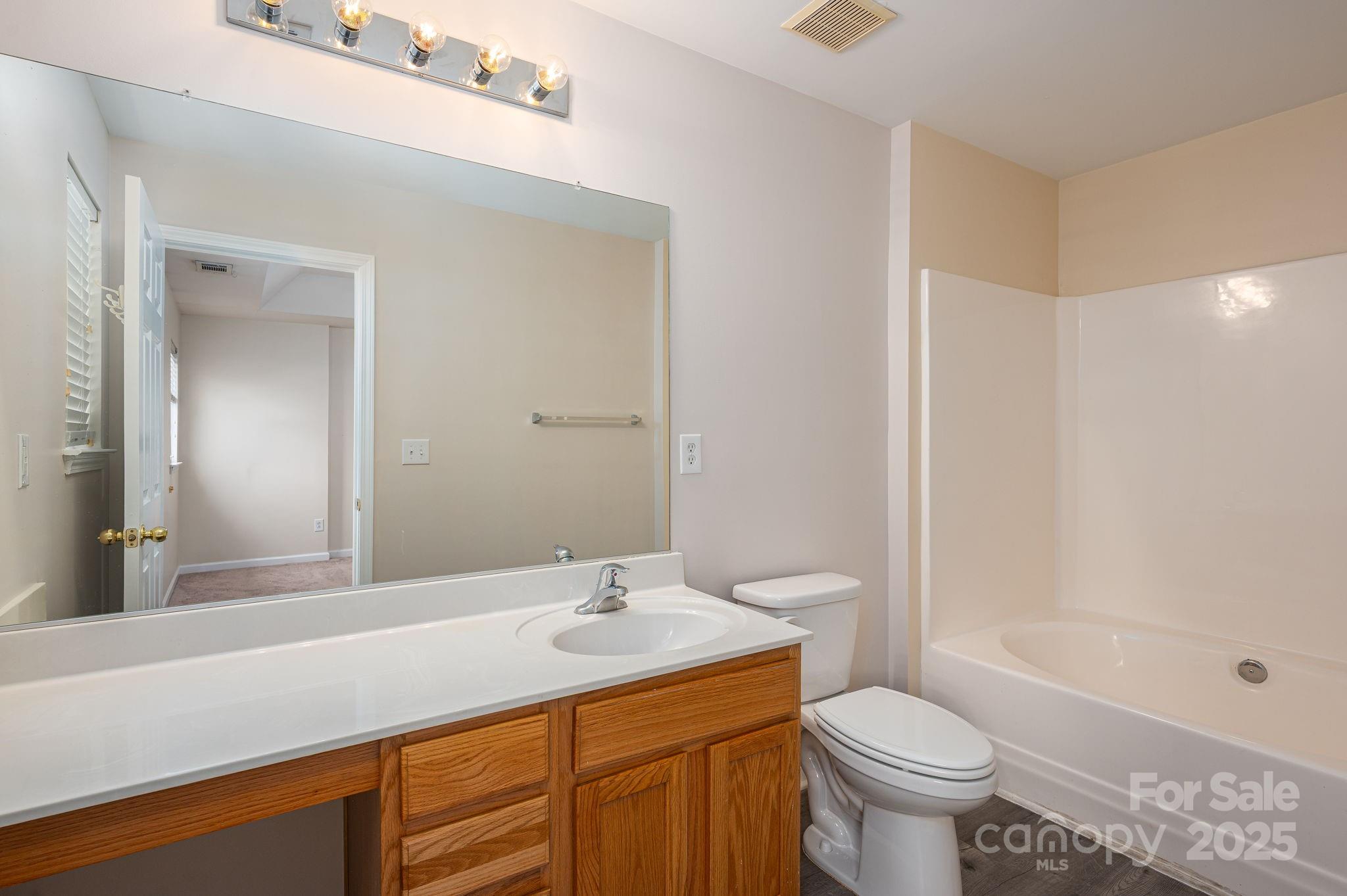 7937 Mariners Pointe Circle Denver, NC 28037 - Photo 23 of 38 a bathroom with a sink toilet and shower