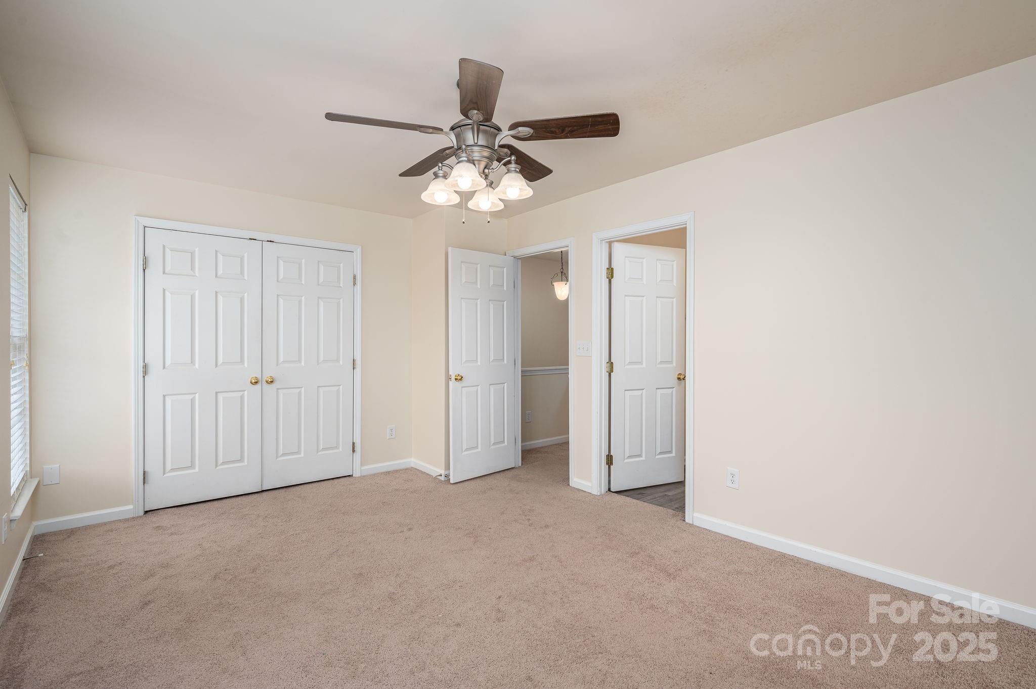 7937 Mariners Pointe Circle Denver, NC 28037 - Photo 25 of 38 a view of an empty room and chandelier fan
