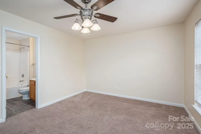 wooden floor in an empty room and a bathroom