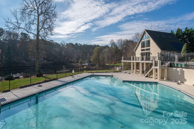 a view of a house with pool and a yard