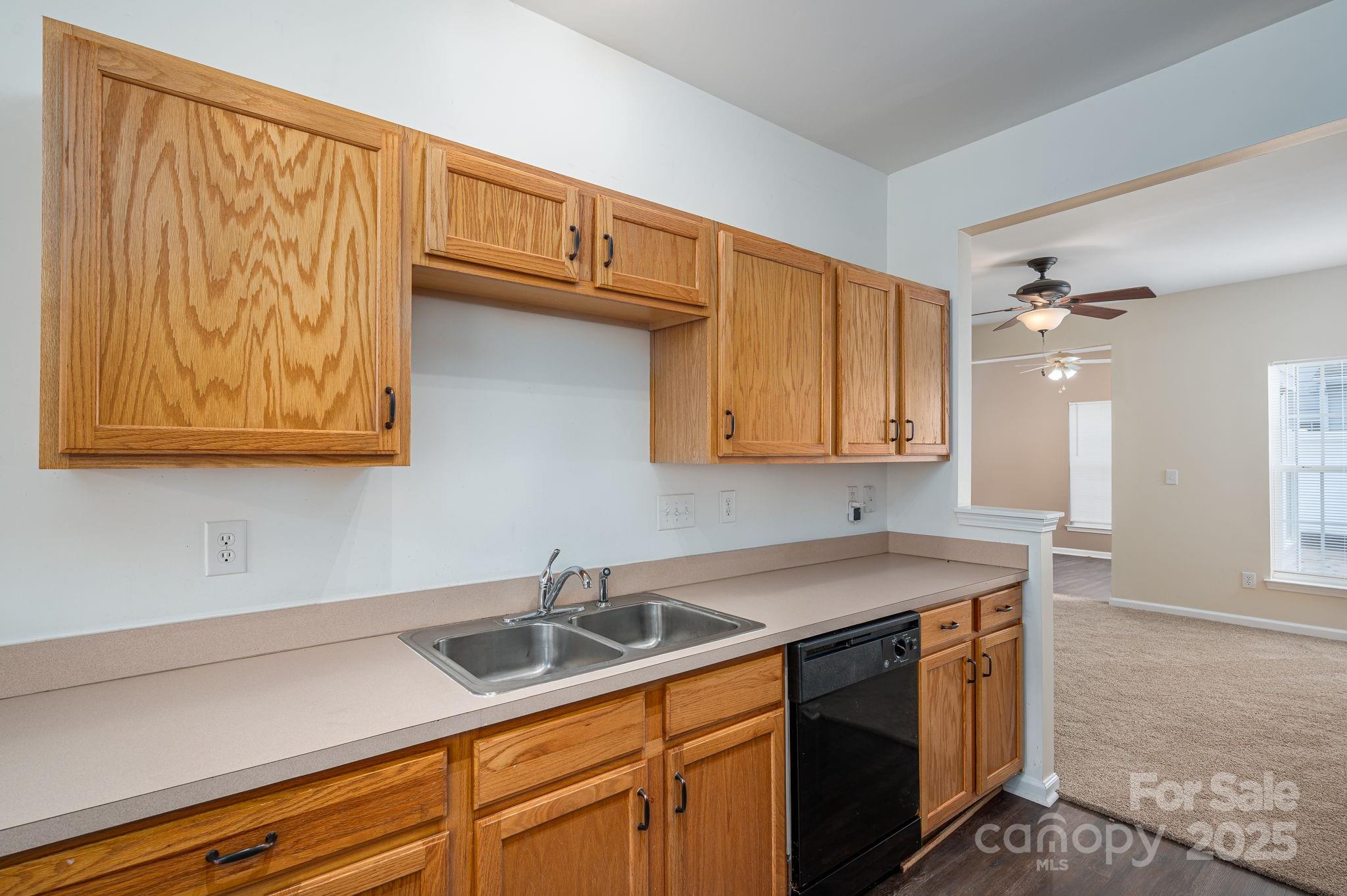 7937 Mariners Pointe Circle Denver, NC 28037 - Photo 9 of 38 a kitchen with stainless steel appliances granite countertop a sink dishwasher cabinets and couches with wooden floor
