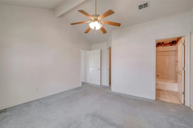 an empty room with closet and a chandelier fan