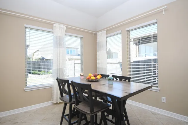 a spacious bedroom with a large bed and a chandelier fan