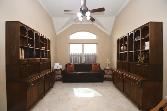 a spacious bedroom with a bed and a large window