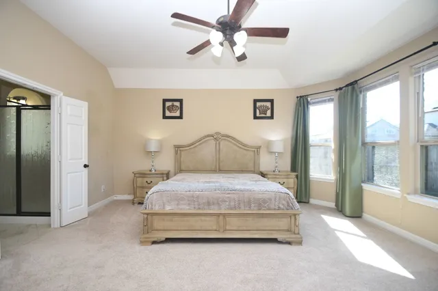a spacious bathroom with a tub sink and mirror