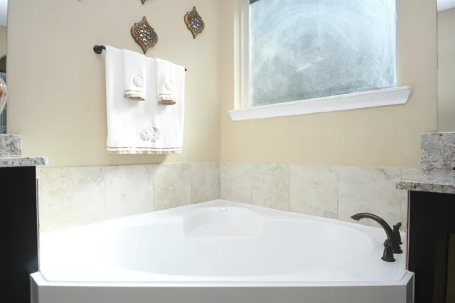 a spacious bedroom with a bed and a painting on the wall