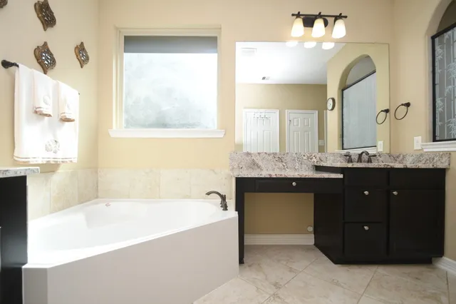 a view of a house with a garden and pathway