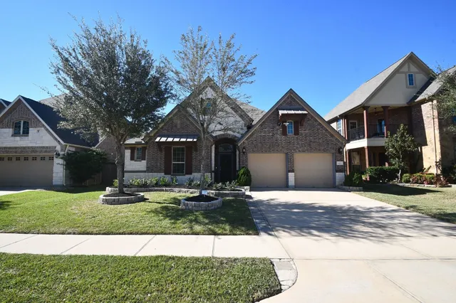 a living room with a couch and kitchen view