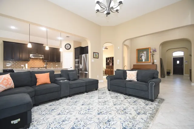 a living room with furniture and kitchen view