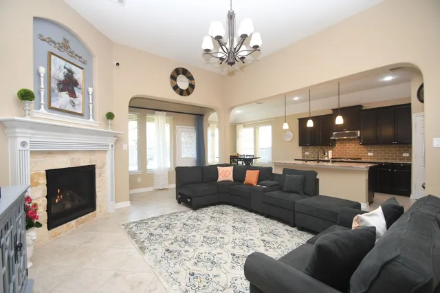 a living room with furniture and a fireplace with wooden floor