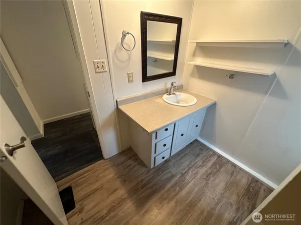 a bathroom with a sink a mirror and a shower