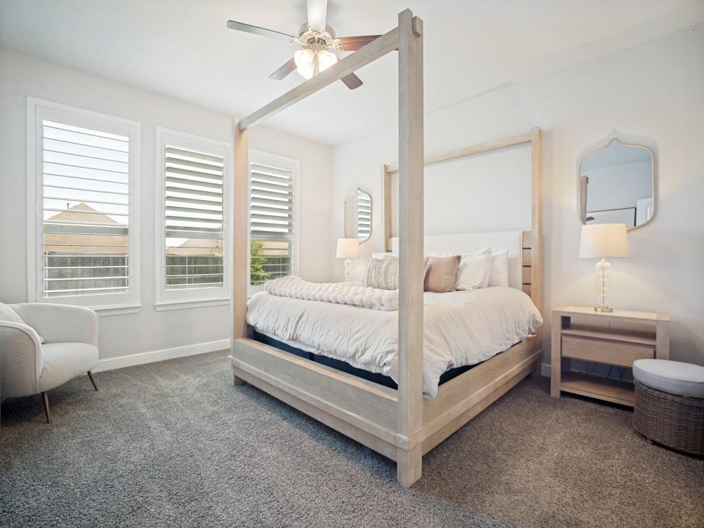 1612 Reed Drive Krum, TX 76249 - Photo 13 of 25 Carpeted room featuring multiple windows with plantation shutters, a ceiling fan, and light-toned walls