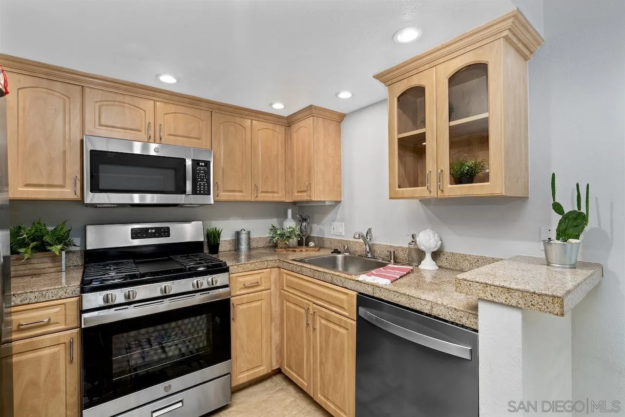 4375 37th Street, Unit 8 San Diego, CA 92105 - Photo 6 of 17 a kitchen with granite countertop a stove sink and microwave