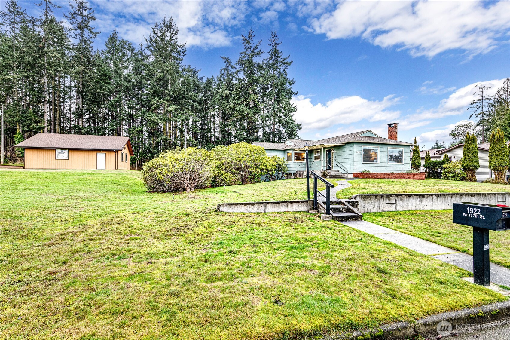a view of a house with pool and a yard