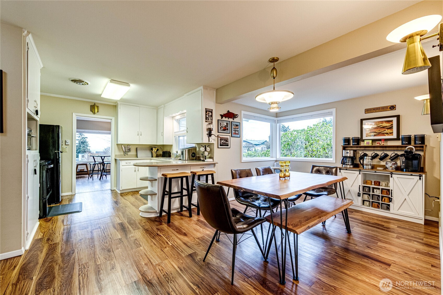 1922 West 7th Street Port Angeles, WA 98363 - Photo 12 of 40 a dining room with stainless steel appliances kitchen island granite countertop a stove top oven a dining table and chairs with wooden floor