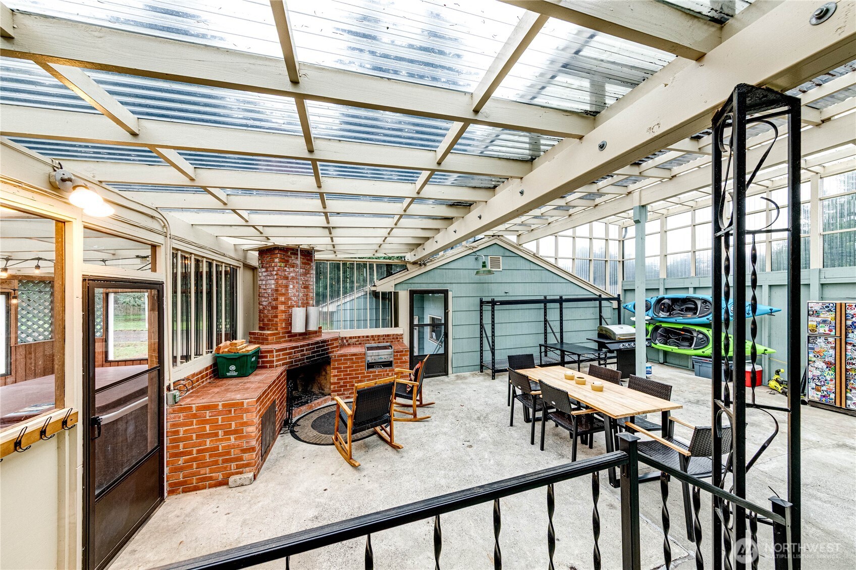1922 West 7th Street Port Angeles, WA 98363 - Photo 24 of 40 a view of a patio with table and chairs with wooden floor and fence