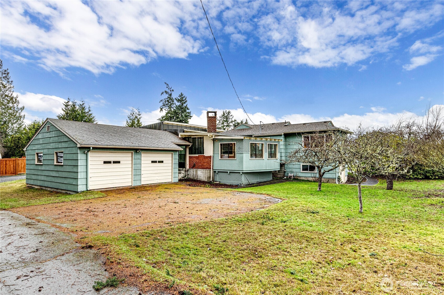 1922 West 7th Street Port Angeles, WA 98363 - Photo 32 of 40 a view of a house with a big yard and a large tree