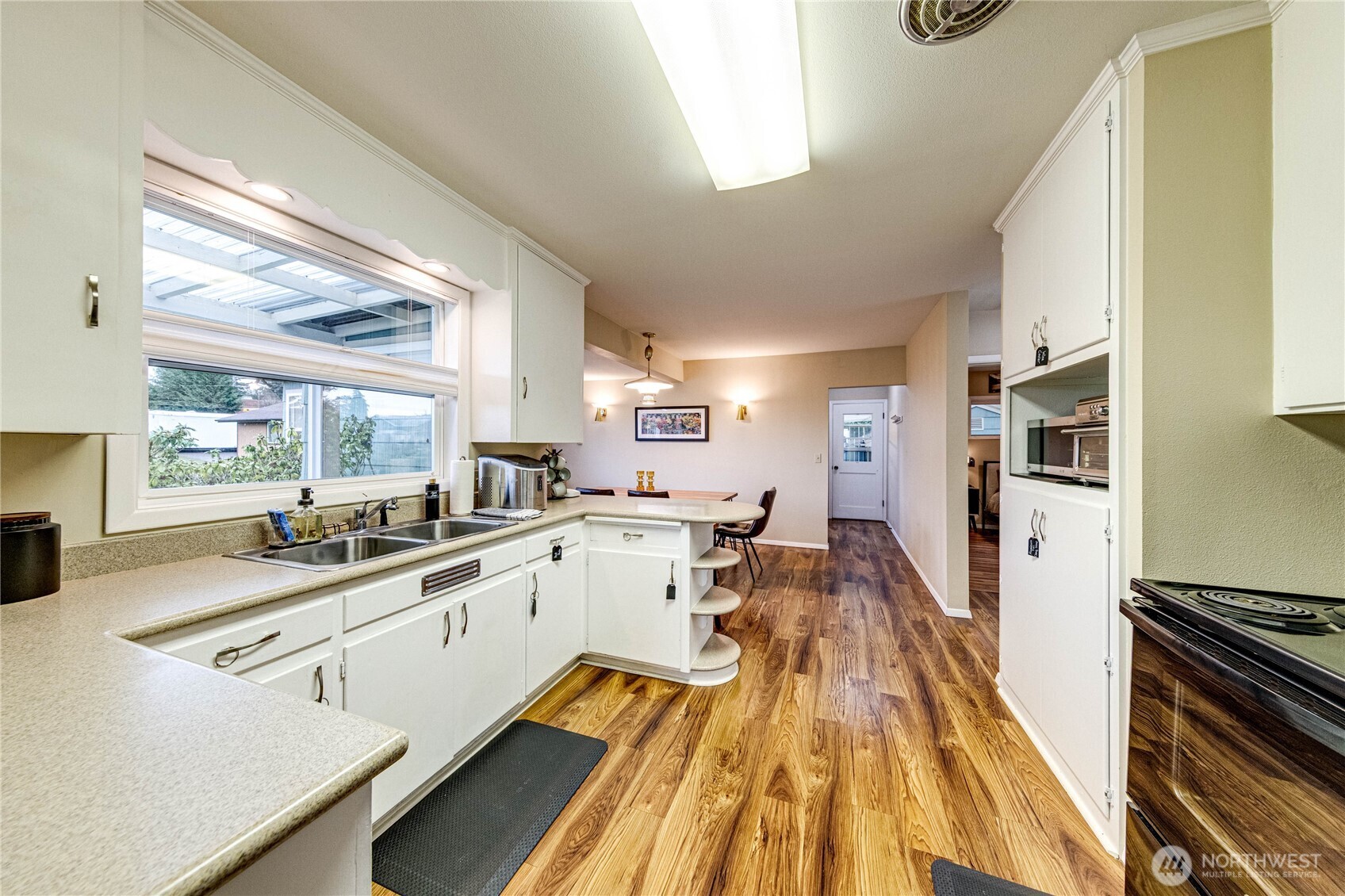 1922 West 7th Street Port Angeles, WA 98363 - Photo 9 of 40 a kitchen with white cabinets and appliances