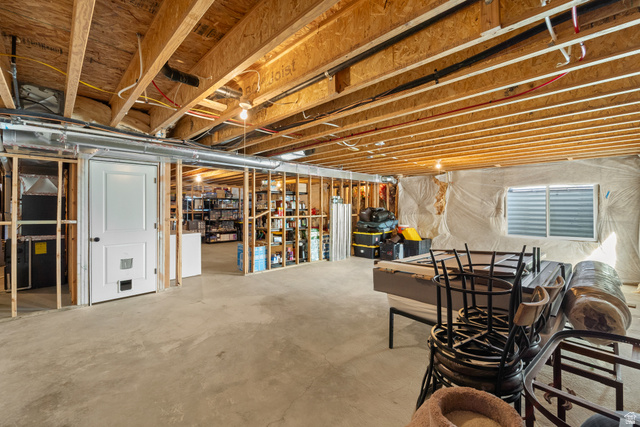 3678 Spiral Springs Road, Unit 204 Tooele, UT 84074 - Photo 36 of 59 Expansive unfinished basement with exposed wood-beam ceiling, recessed lighting, and concrete flooring