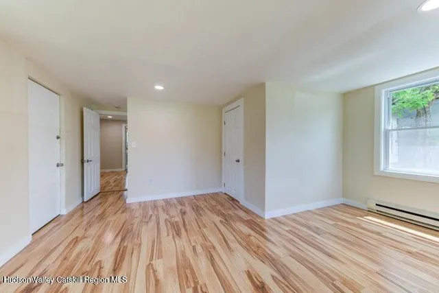 a view of a room with wooden floor and window