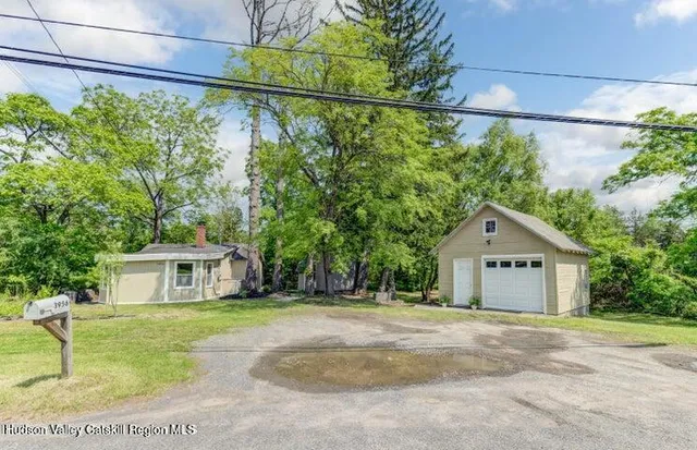 a front view of a house with a garden and yard