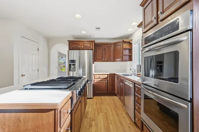 a kitchen with a appliances a sink and cabinets