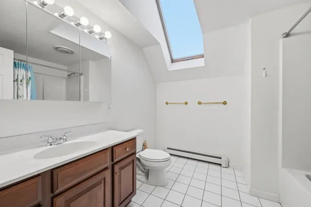 a bathroom with a sink a toilet and a mirror