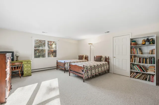 a bedroom with furniture and a book shelf