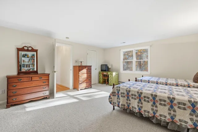 a bedroom with bed and window