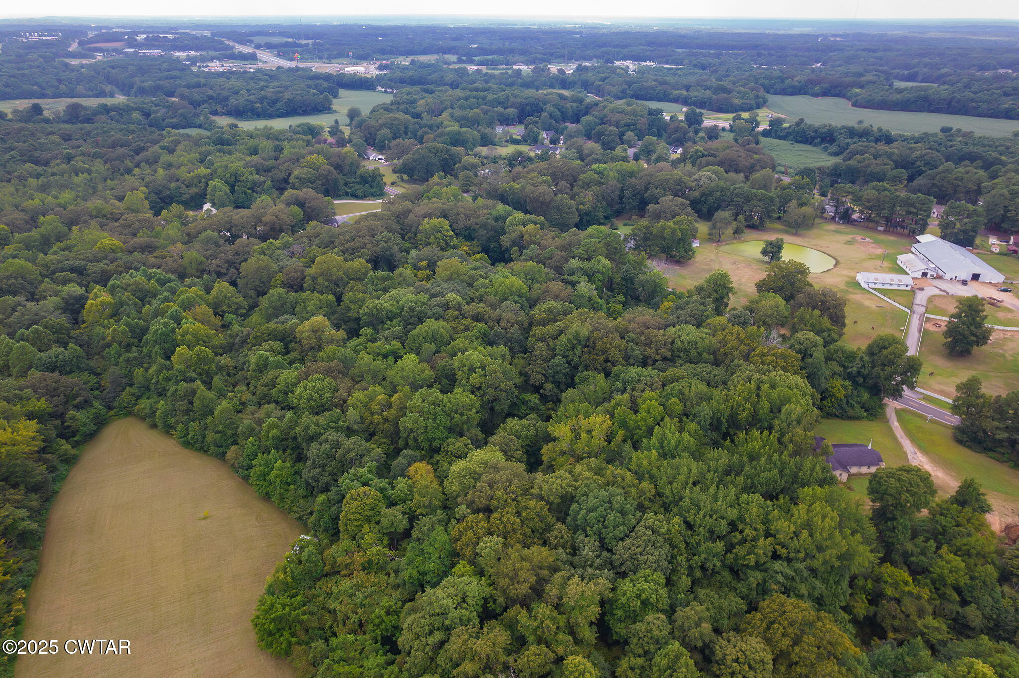 0 Us-412 Jackson, TN 38305 - Photo 7 of 9 an aerial view of a house with a yard and lake view
