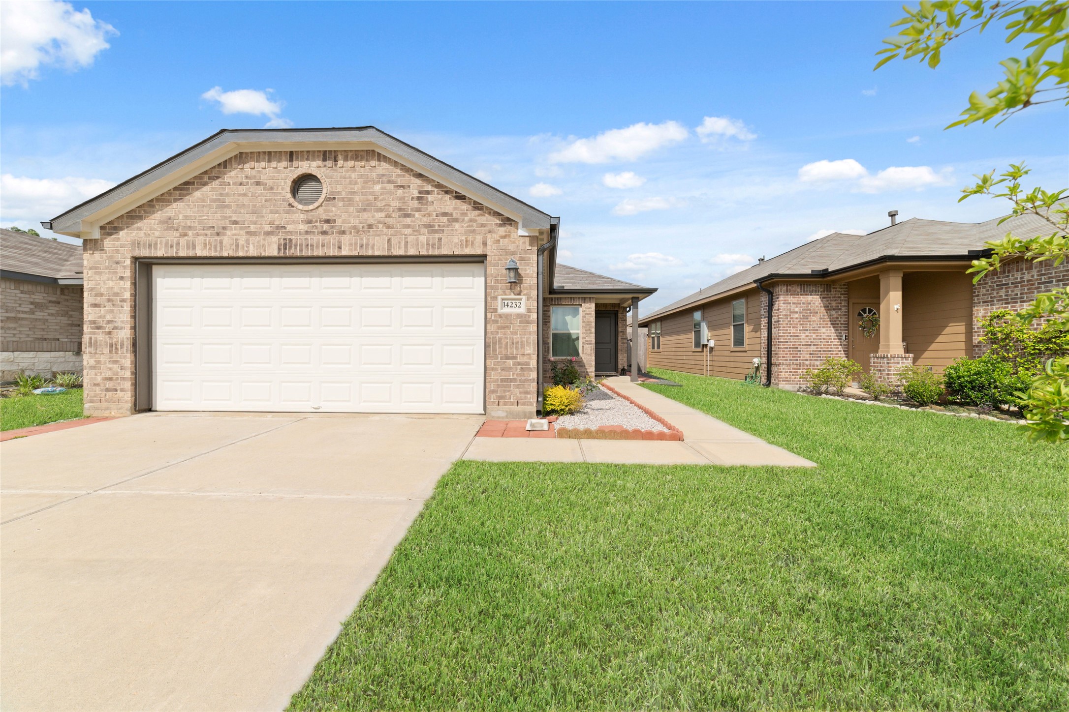 14232 Shasta Ridge Drive Conroe, TX 77303 - Photo 2 of 26 Inviting front elevation with classic brick detail and a bright entry path leading you home.