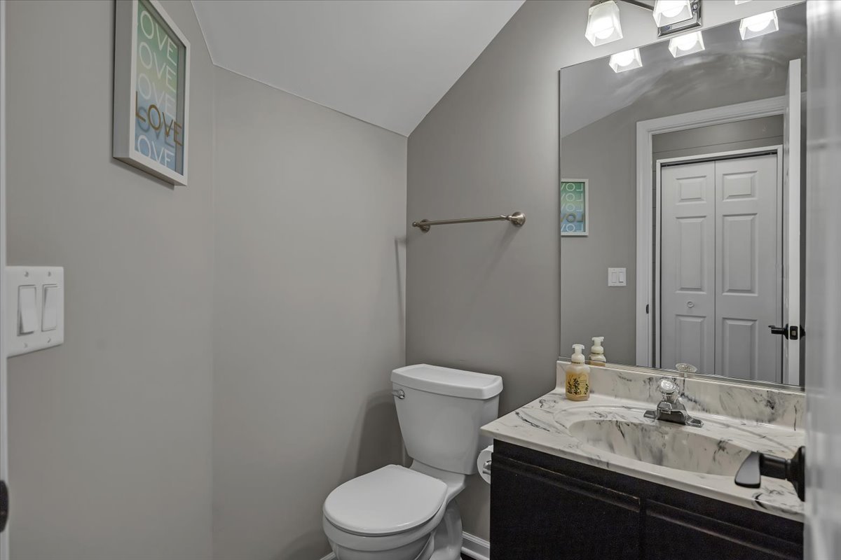 2070 Constitution Court Elgin, IL 60123 - Photo 15 of 29 a bathroom with a toilet a sink and mirror