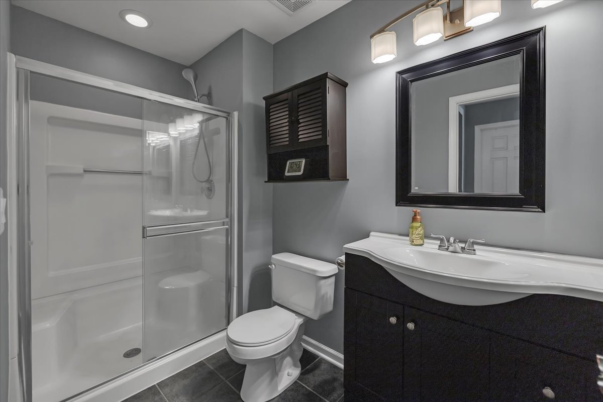2070 Constitution Court Elgin, IL 60123 - Photo 18 of 29 a bathroom with a toilet sink double vanity and mirror