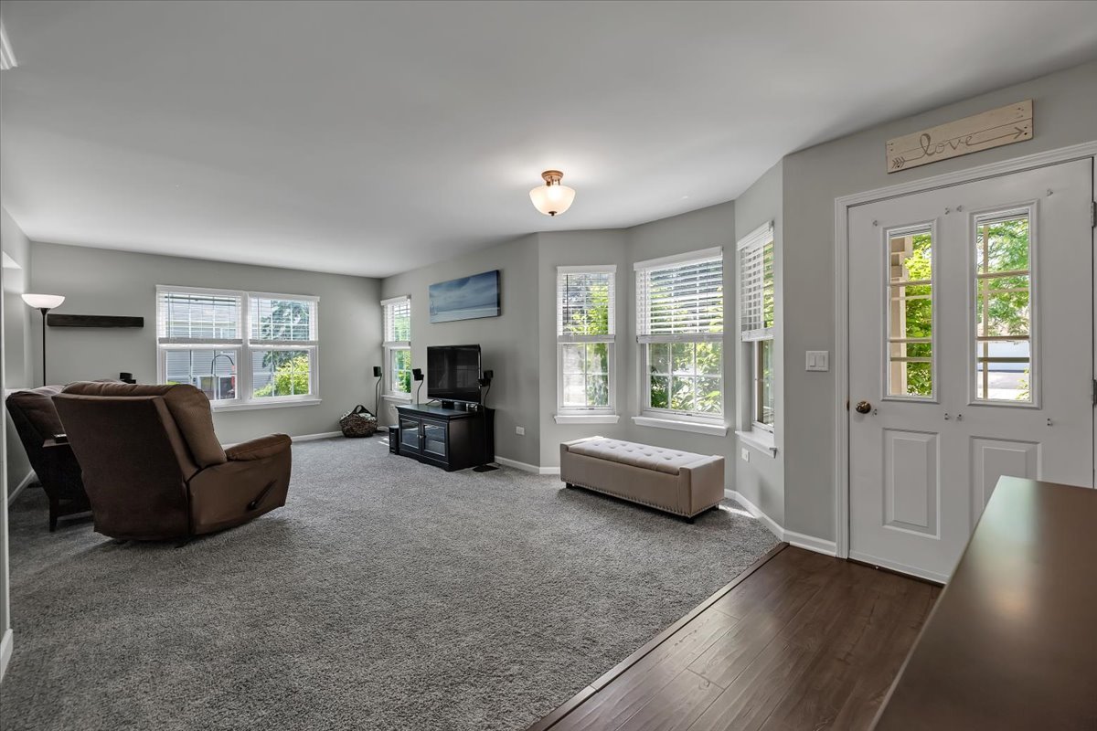 2070 Constitution Court Elgin, IL 60123 - Photo 2 of 29 a living room with furniture and a large window