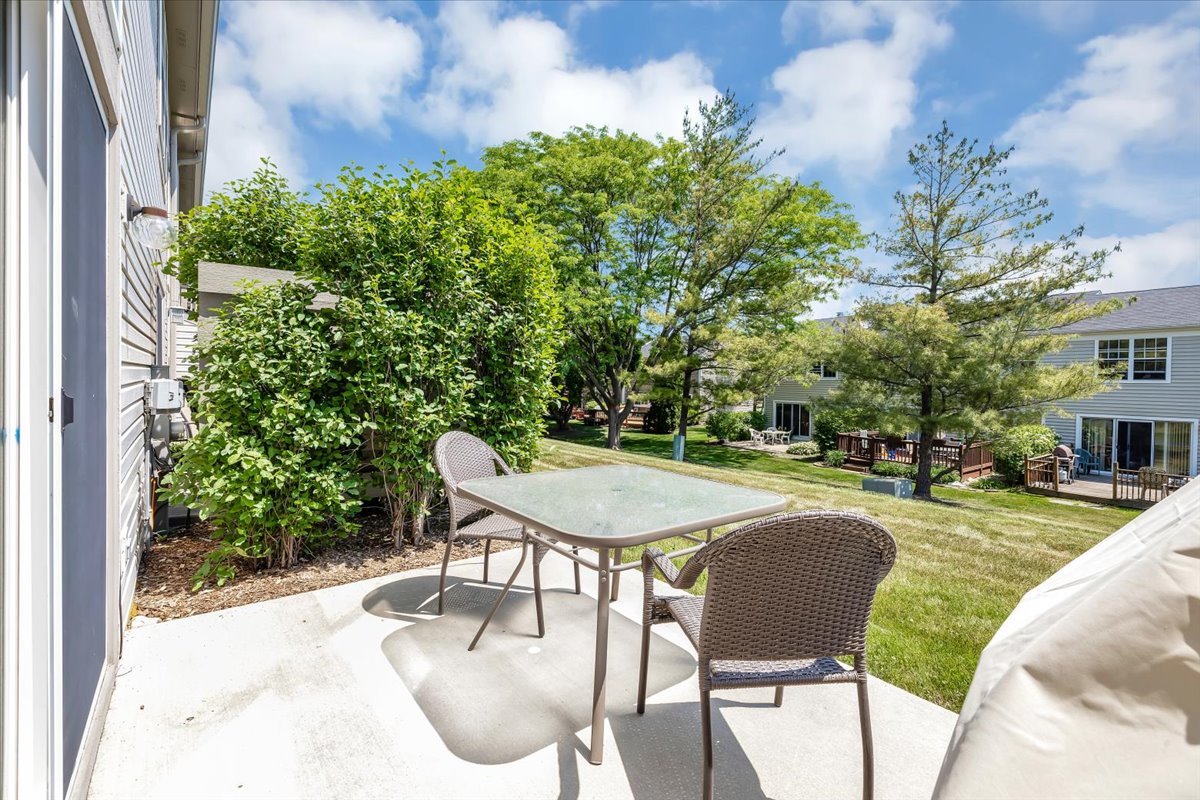 2070 Constitution Court Elgin, IL 60123 - Photo 29 of 29 a view of a patio with table and chairs and potted plants