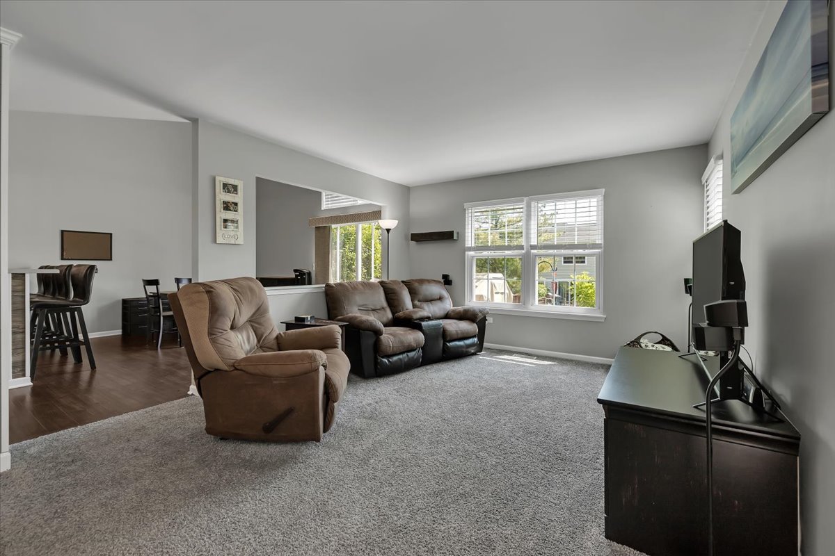 2070 Constitution Court Elgin, IL 60123 - Photo 3 of 29 a living room with furniture and a flat screen tv