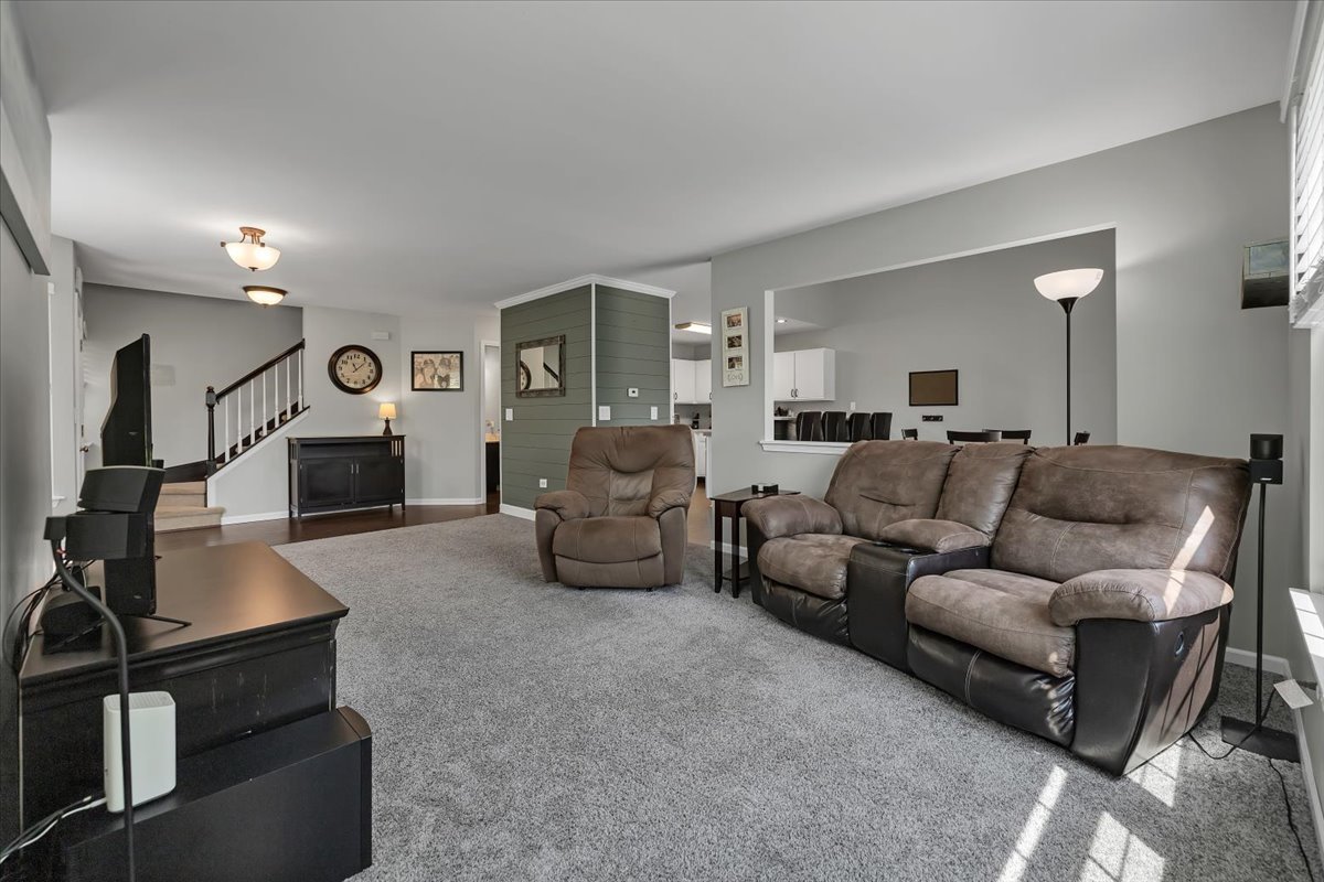2070 Constitution Court Elgin, IL 60123 - Photo 4 of 29 a living room with furniture and a wooden floor