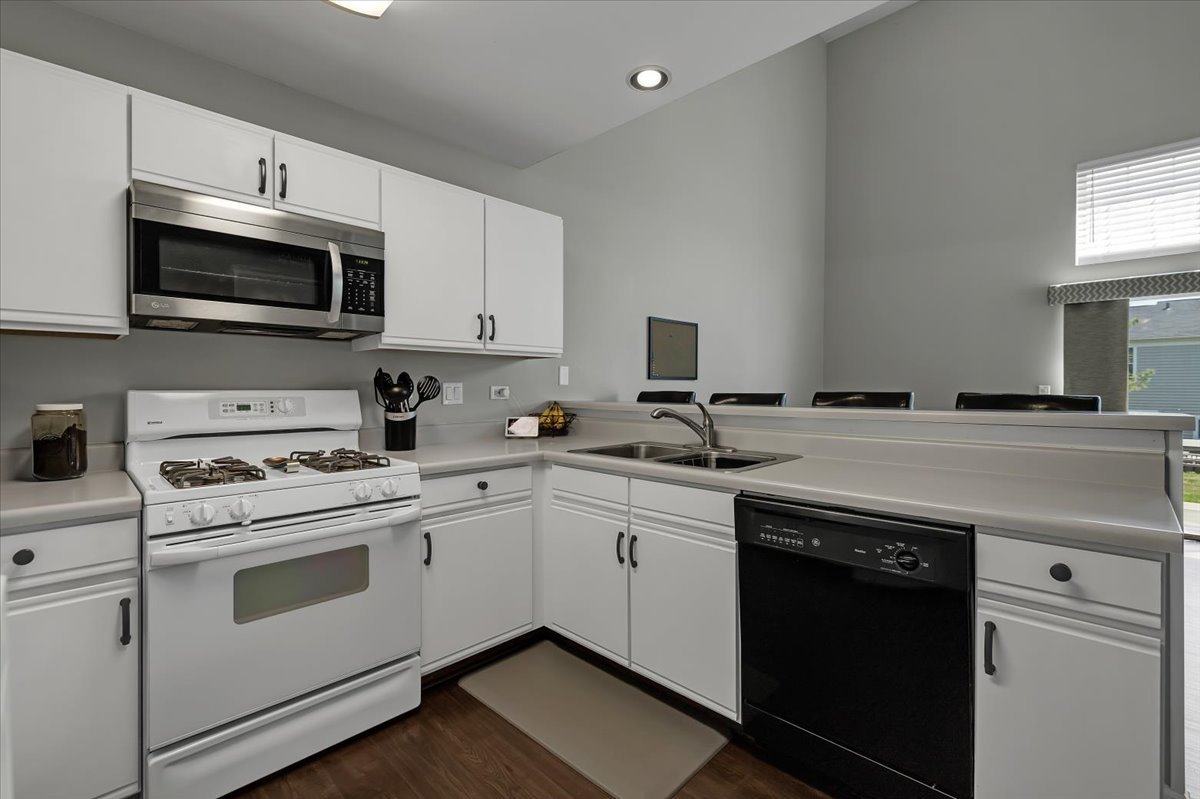2070 Constitution Court Elgin, IL 60123 - Photo 8 of 29 a kitchen with stainless steel appliances granite countertop a sink a stove a microwave and cabinets