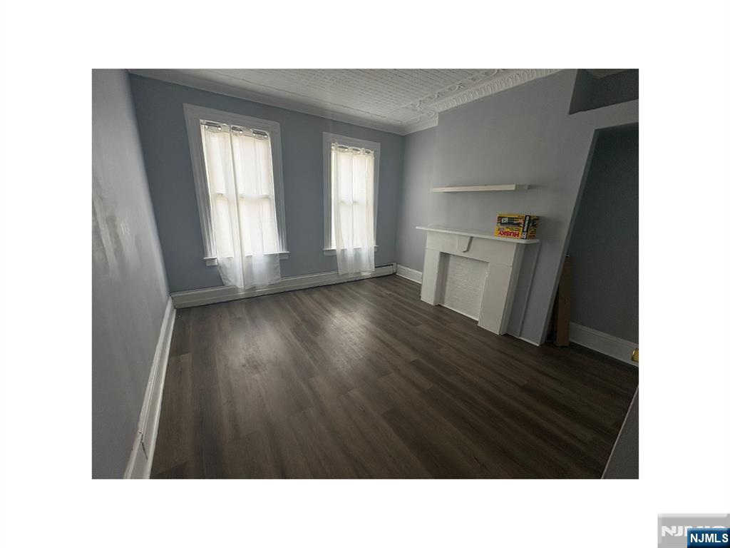 93 Highland Street, Unit 2 Paterson, NJ 07524 - Photo 5 of 9 a black and white photo of a living room