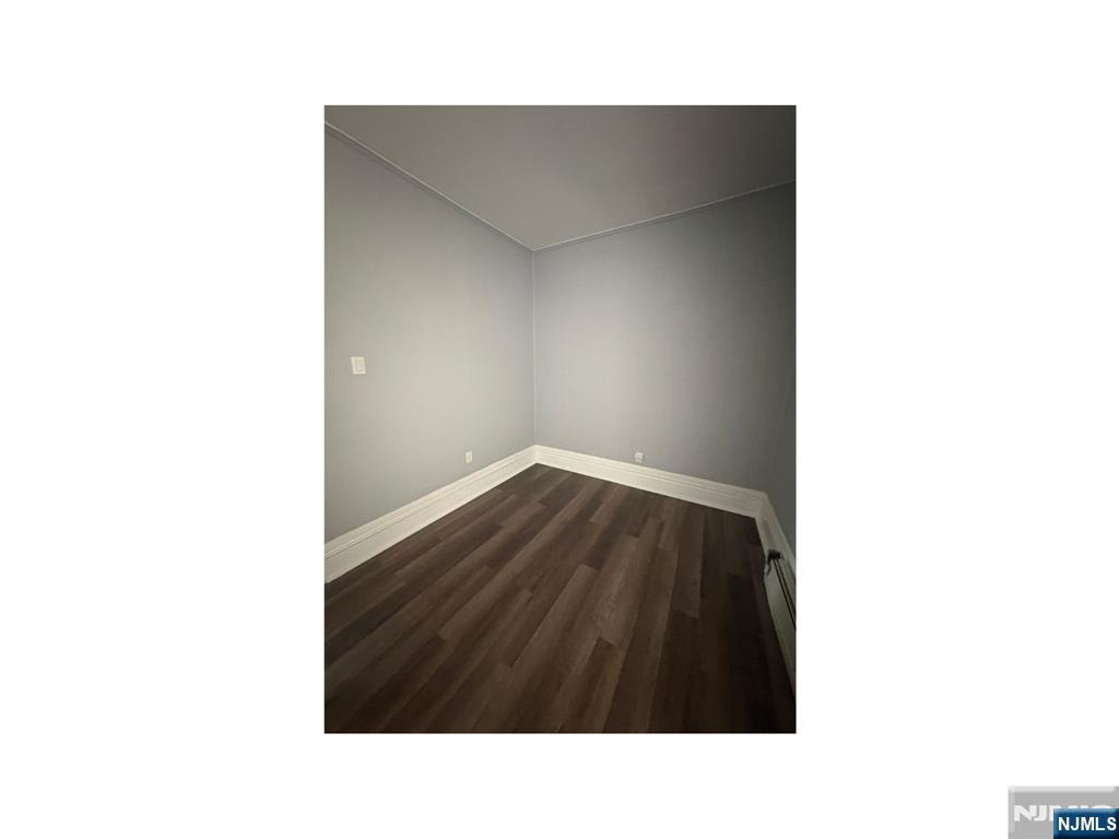 93 Highland Street, Unit 2 Paterson, NJ 07524 - Photo 6 of 9 a black and white photo of a room