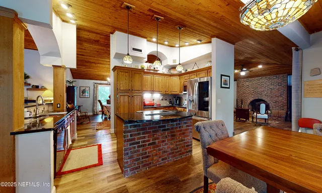 a view of a dining room with furniture large windows outdoor and garden view