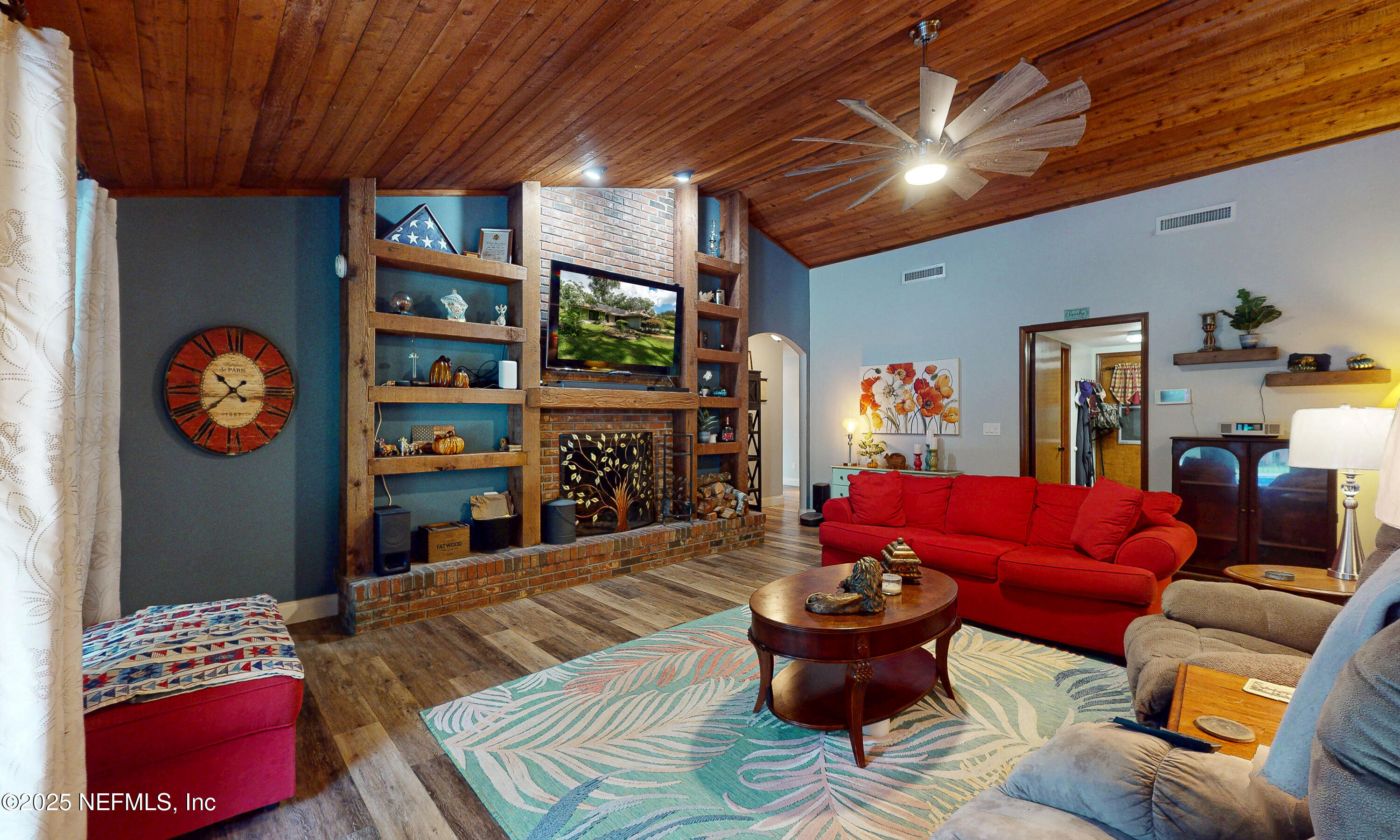 2860 Ravines Road Middleburg, FL 32068 - Photo 15 of 52 a living room with furniture and a flat screen tv