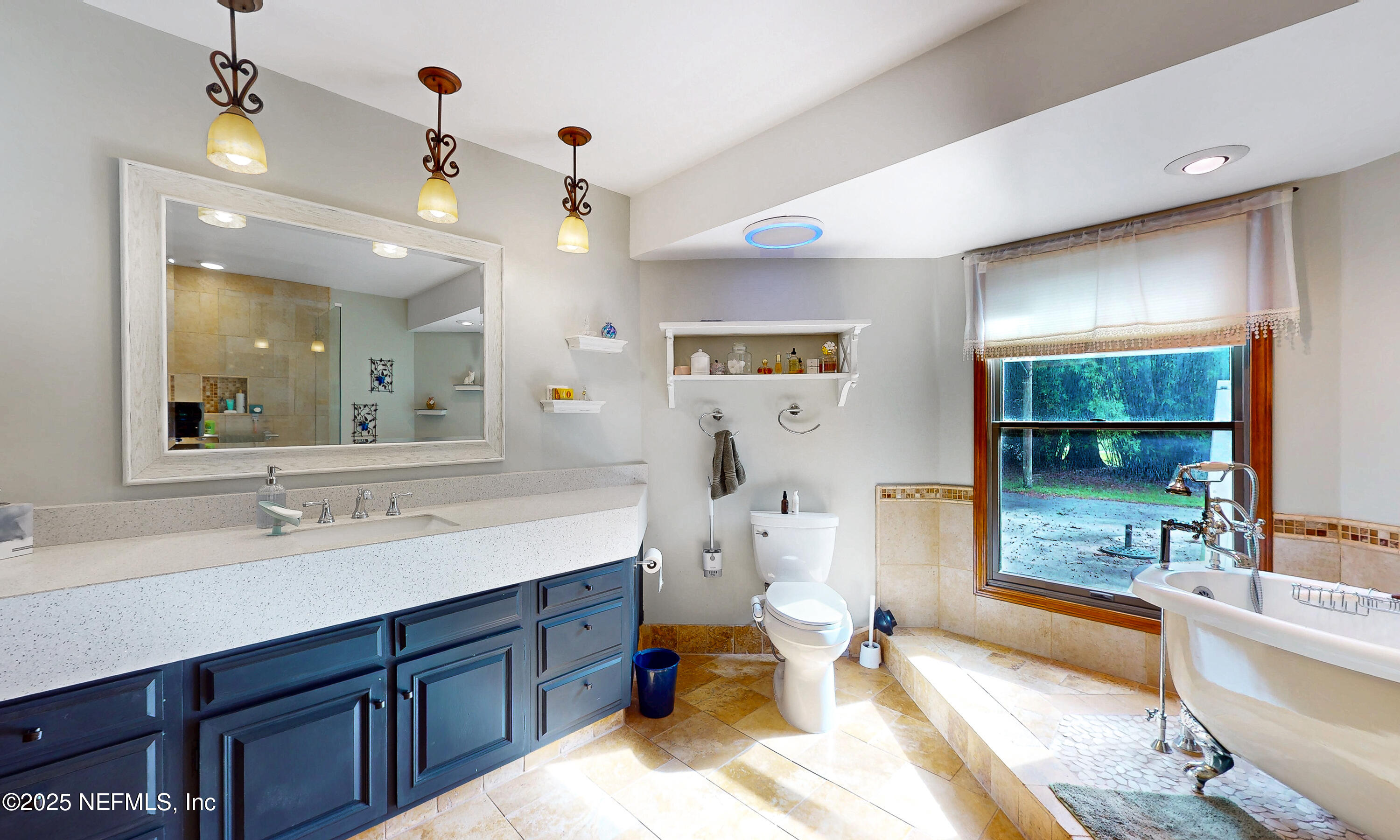 2860 Ravines Road Middleburg, FL 32068 - Photo 20 of 52 a spacious bathroom with a double vanity sink a mirror and a bathtub