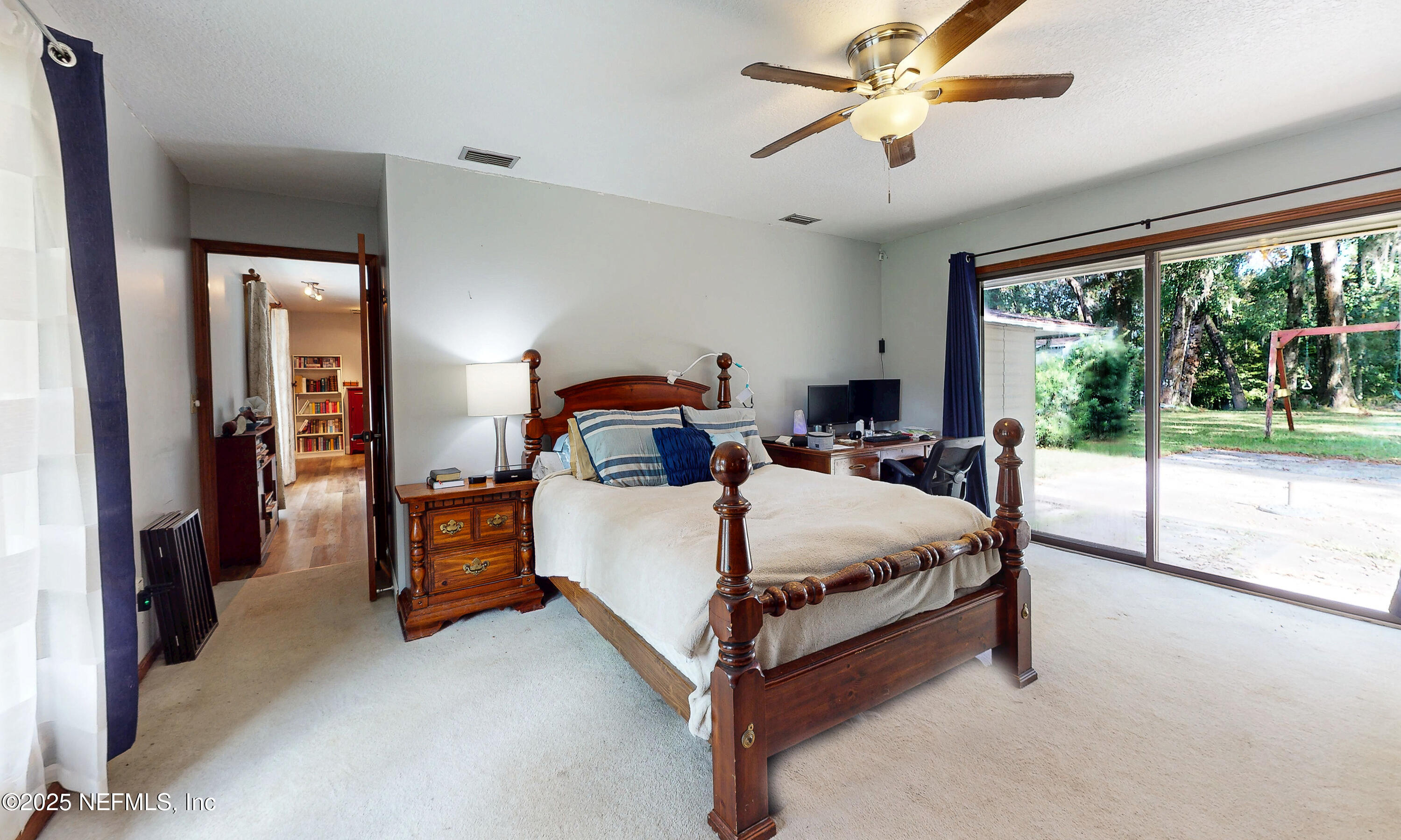 2860 Ravines Road Middleburg, FL 32068 - Photo 24 of 52 a bed sitting in a bedroom next to a large window