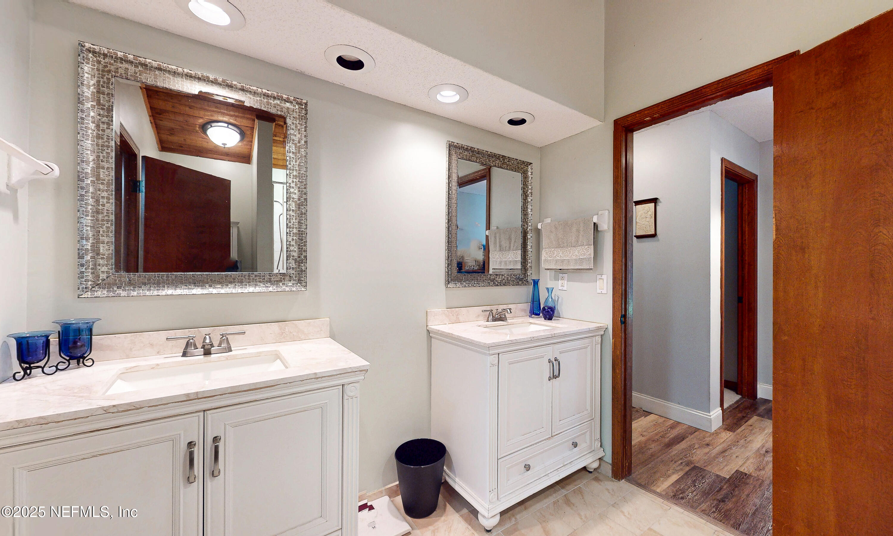 2860 Ravines Road Middleburg, FL 32068 - Photo 26 of 52 a bathroom with a double vanity sink and mirror